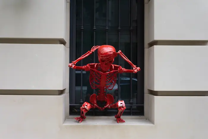 A photo of a red skeleton in a window